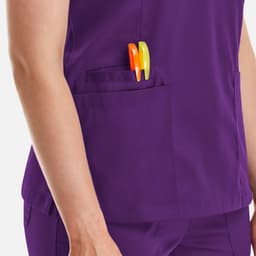 A purple women's top with a double V-neck and two pens in the pocket.