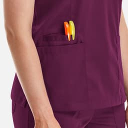 A purple women's double V-neck top featuring a side pocket with pens. The top has a logo on it.