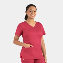 A woman wearing a vibrant raspberry-coloured double V-neck top with a pocket, featuring a branding logo.