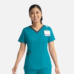 A teal women's top with a contrast double V-neck, featuring a logo and a name badge attachment.