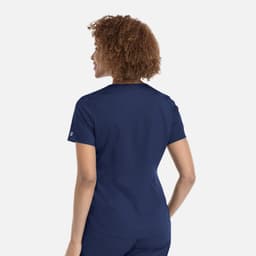 A women's tuckable V-neck top in navy, featuring a fitted design and a logo on the sleeve.