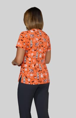 An orange top with a print of various cartoon characters, featured on a model from the back.