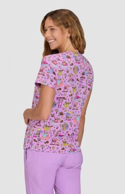 A lilac patterned top featuring a playful design with various colourful illustrations. It has a round neck and short sleeves.