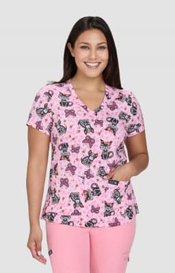 A pink patterned top featuring butterflies and floral designs, with a V-neck and short sleeves.