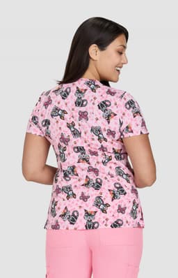 A short-sleeved top featuring a pink butterfly print, designed with a fitted silhouette and a branded logo.