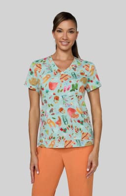 A woman wears a light blue top with a vibrant, multi-coloured pattern of various tropical elements.