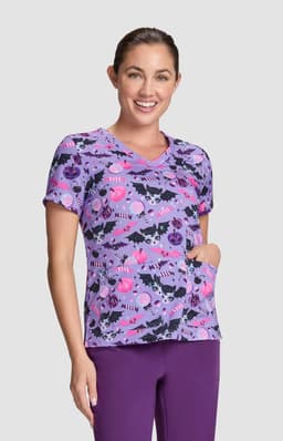 A short-sleeved purple top featuring a playful Halloween-themed print with various designs and a pocket.
