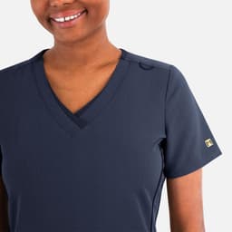 A navy blue women's layered V-neck top with a short sleeve and a discreet logo on the sleeve.