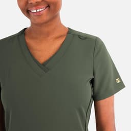 A layered v-neck top in olive green with short sleeves and a subtle logo on the sleeve.