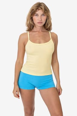 A yellow spaghetti tank top paired with blue shorts, featuring a branding logo.