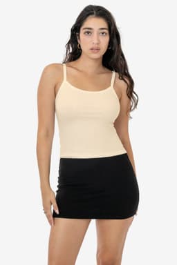 A light beige spaghetti tank top paired with a black mini skirt. The top features thin shoulder straps.