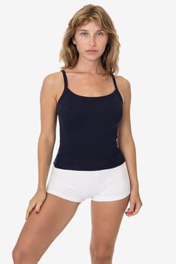 A navy blue spaghetti tank top paired with white shorts, modelled by a woman against a plain background.