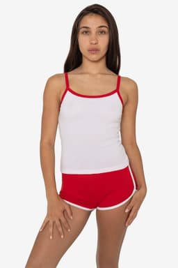 A model wears a white rib spaghetti tank top with red trim, paired with red shorts featuring white edges.