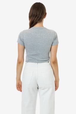 A grey mid-length baby rib crewneck tee displayed from the back, paired with white trousers. The shirt has a fitted design.