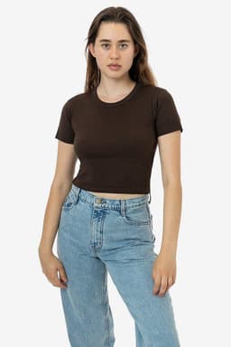 A mid-length baby rib crewneck tee in brown, worn with light blue jeans. The model poses against a plain background.