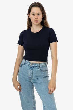 A navy mid-length baby rib crewneck tee displayed on a model, paired with light blue jeans. The shirt has a logo.