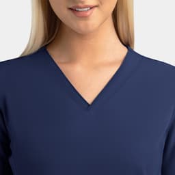 A women's navy v-neck top featuring a contrast design, with a close-up view of the neckline and upper chest area.