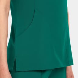 A women's v-neck top in a rich green colour, featuring a side pocket and a sleek design.