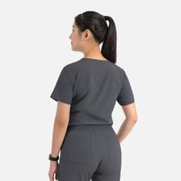 A grey V-neck top with short sleeves, featuring a tuckable design and logo on the back.