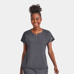 A women's grey notched neck dolman top featuring short sleeves and a chest pocket. The top has a branding logo.