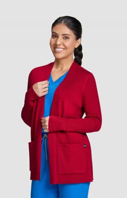 A red Kori Sweater with a relaxed fit, featuring pockets and a woman wearing it, styled with a blue outfit.