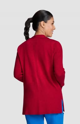 A red ribbed Kori sweater featuring a back split design, worn by a model with a ponytail.