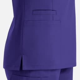 A purple women's double V-neck top with a side slit and pocket detailing. It features a smooth fabric texture.