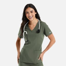 A woman wearing a green double V-neck top with a stethoscope around her neck and pockets. The top has a logo.