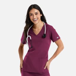 A woman wearing a burgundy double V-neck top with a stethoscope around her neck and pockets on the front.