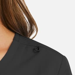 A close-up of a women's mock wrap top in black fabric, featuring a neckline detail and a logo.