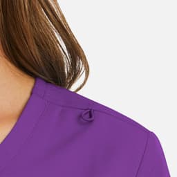 A purple women's mock wrap top featuring a neckline detail and a subtle logo.