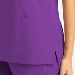 A purple mock wrap top featuring a pocket and a side slit detail. The fabric appears smooth and lightweight.