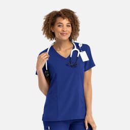 A women's mock wrap top in royal blue, featuring a v-neckline and a stethoscope around the neck.