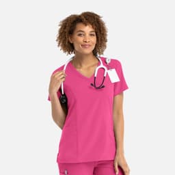A women's mock wrap top in vibrant pink with a V-neck design, featuring a stethoscope and a logo.
