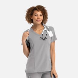 A women's grey mock wrap top with short sleeves and a stethoscope around the neck, featuring a logo.