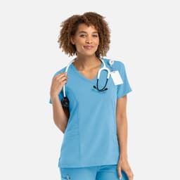 A light blue women's mock wrap top with a V-neckline, featuring a logo and a stethoscope around the neck.