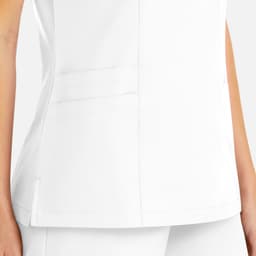 A white women's mock wrap top featuring pockets and a fitted design. The top has a logo on it.