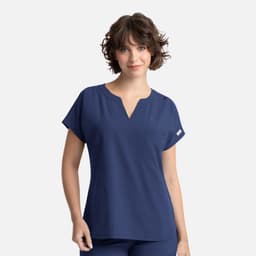A women’s navy blue top featuring dolman sleeves and a pocket, with a logo on the side.