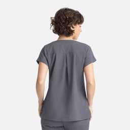 A grey women's dolman top featuring short sleeves and a pleated back design. The product has a logo.
