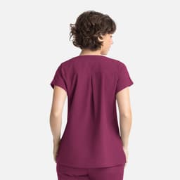 A women's dolman top in a rich plum colour, featuring a relaxed fit and short sleeves, with a back pleat detail.