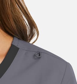 A mock wrap top in grey with a contrast trim, featuring a small loop detail on the shoulder.