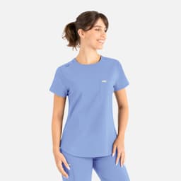 A light blue round neck top with a pocket, designed as part of scrubs uniforms, featuring a logo on it.