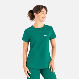 A green scrub top with a round neck, featuring a pocket and a small logo on the chest.
