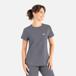 A grey round neck scrub top with short sleeves and a pocket, featuring a logo on the chest.