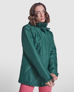 A green women's parka with a high collar, featuring a zip and side pockets, displayed on a model.