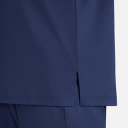 A close-up of a navy blue men's tuckable henley top, showcasing the hem detail and side slit.