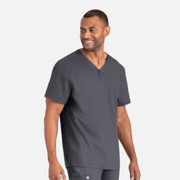 A man wearing a dark grey henley top with a buttoned neckline. The shirt has branding visible.