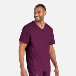 A man in a deep burgundy Henley top with a subtle logo displayed on the side.