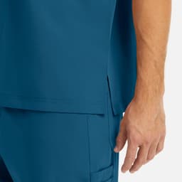 A close-up of a men's tuckable v-neck top in a deep blue colour, featuring a side slit design.