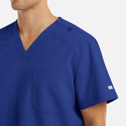 A men's v-neck top in royal blue with a pocket and branding on the sleeve.